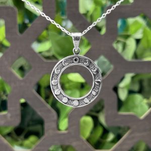 The Moon Phase Pendant by County Argyle hand-cast in sterling silver